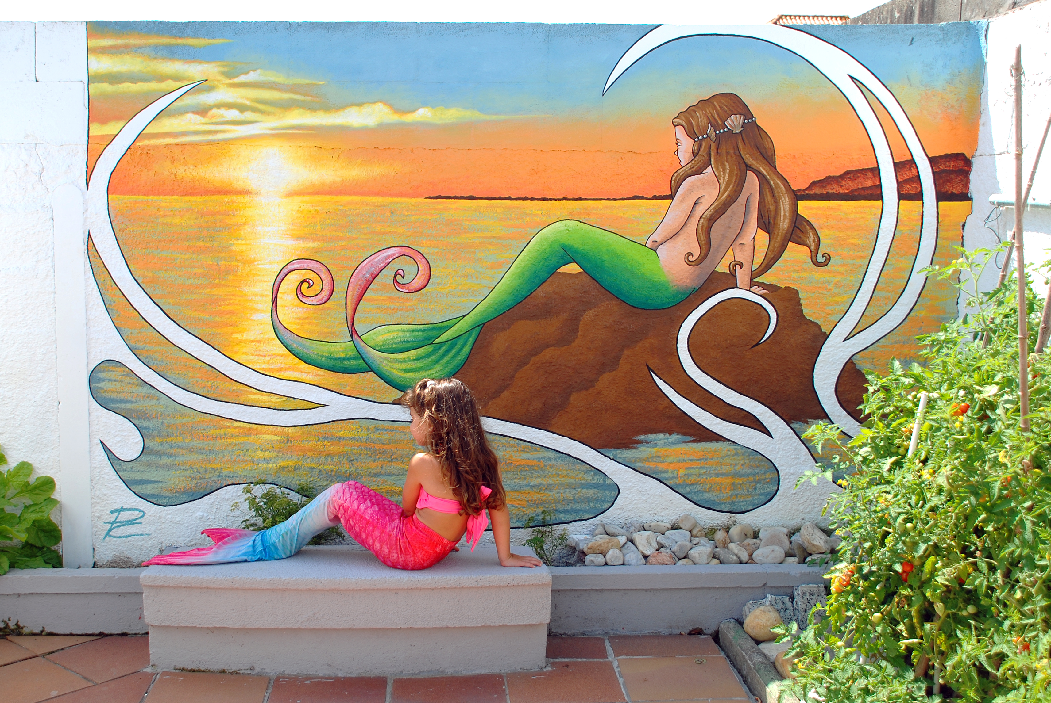 mural de sirena con puesta de sol de fondo